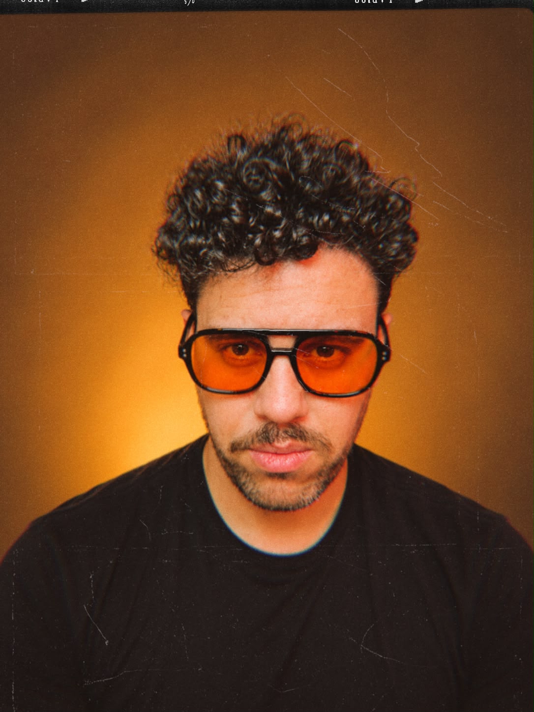 Portrait of Leonardo Franca wearing orange tinted glasses
